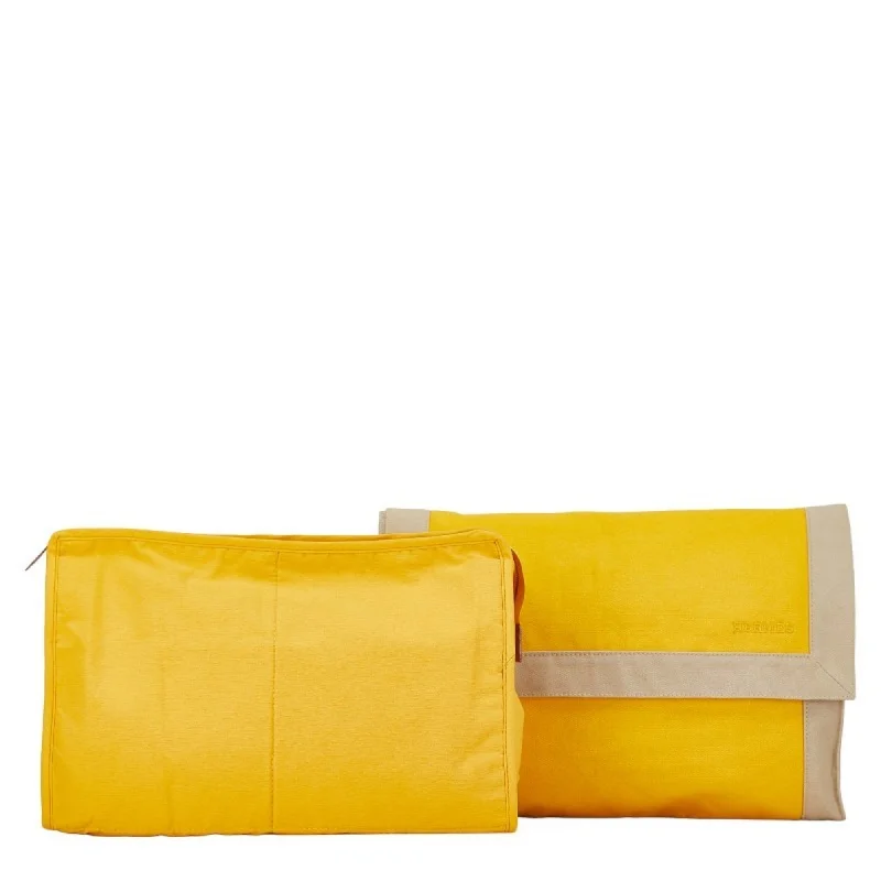 Handle bags with elegant gold-tone hardware -Hermes  yellow Canvas Clutch Bag (Pre-Owned)