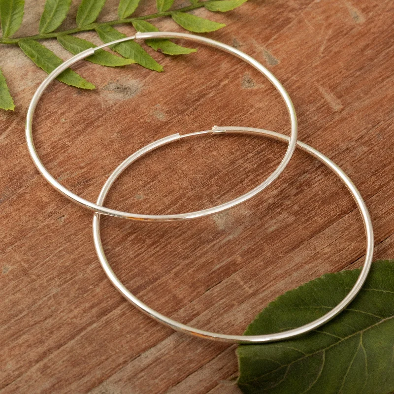 Best hoop earrings with gold-plated finishes for an affordable luxury vibe-Novica Handmade Light Rings Sterling Silver Hoop Earrings